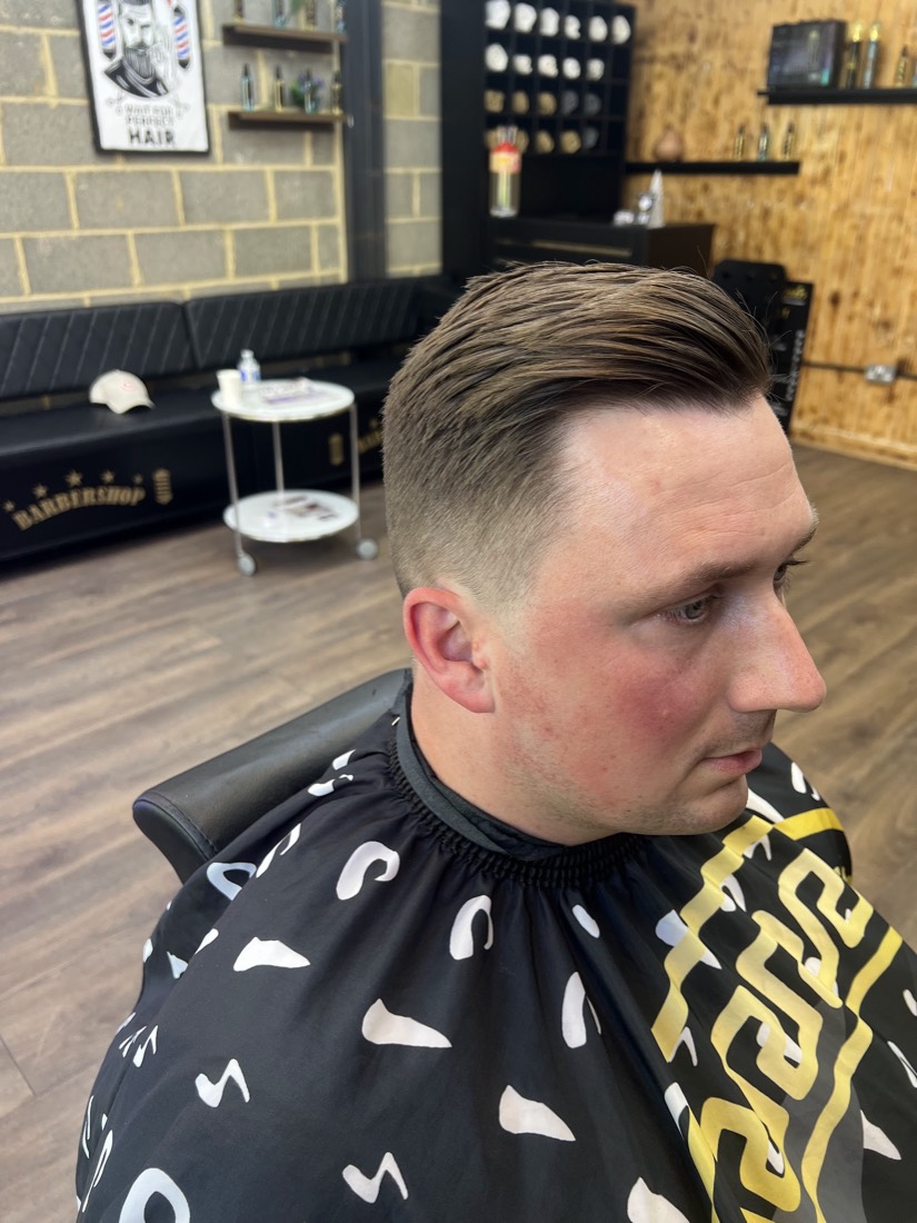 Sharp side-part with a fade and razor line, Golden Razor Barbers